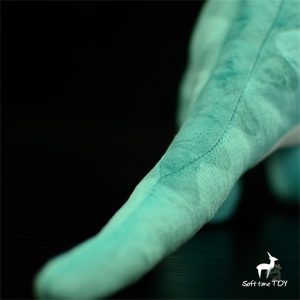 Peluche verte au design de dinosaure amusant